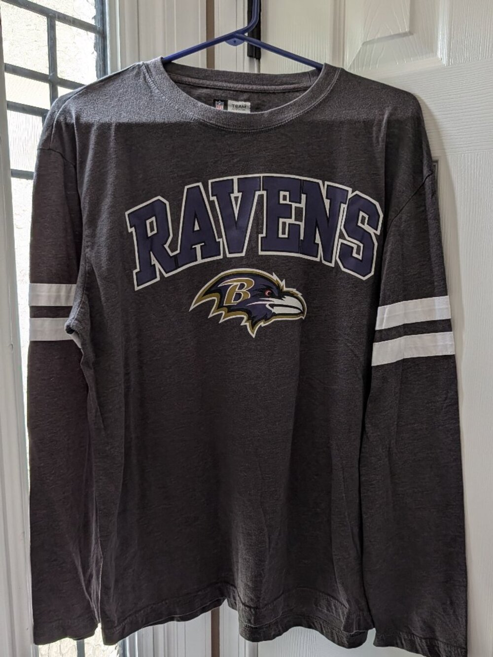 Bring your game day to life with the Official NFL Baltimore Ravens Crew-Neck Lon
